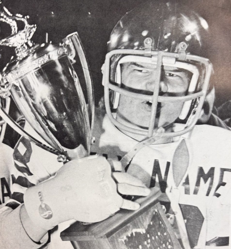A Green Wave player with the state championship trophy